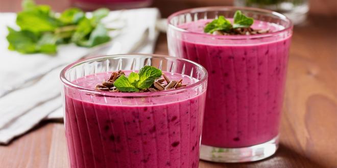 cups of berry yogurt smoothies with mint garnish